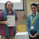 Joshua Cooper receiving trainer certificate from partiicpant