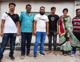 Four Bangladeshi trafficking victims who were rescued in West African country of Togo along with officials of supportive organisations pose for a photograph after their return to Bangladesh on Saturday. Photo: collected