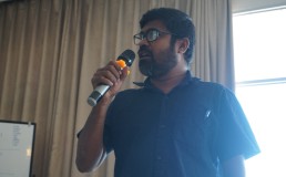 Photo of Letchumanan speaking into a microphone. Credit: DTP