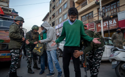 Indian paramilitary soldiers frisk Kashmiris during a surprise check operation in Srinagar [Dar Yasin/AP]