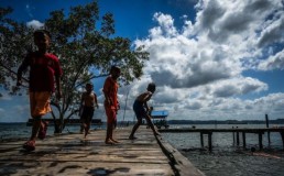 Leisure time: Children play near a pier on Feb. 17, 2024 at Lango beach in North Penajam Paser regency in East Kalimantan. Local people have asked the government not to relocate them amid the development of the Nusantara Capital City (IKN). Credit: Antara/Rivan Awal Lingga