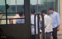 Group of men stand outside a building in a circle. Credit "John"/Fortify Rights website