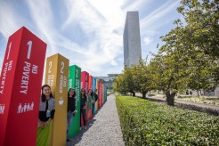 UN staff members with the SDGs outside UN Headquarters. Credit: UN Photo/Laura Jarriel
