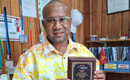 Photo of Jonathan Mesulam holding 2026 Defender of Democracy Award