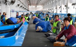 Chinese workers sort out parcels, most of which are from Singles' Day online shopping, at a distribution center in Nanchang city, east China's Jiangxi province, 14 November 2018. Credit: ChinaImages