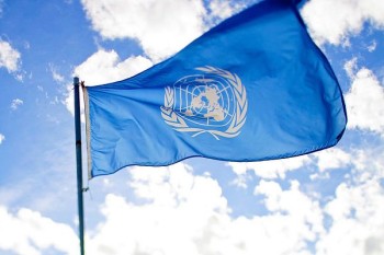 UN flag flying in front of a blue sky with hite clouds. Credit: Flickr/ sanjitbakshi