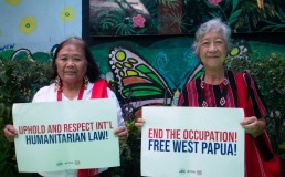 Members of the Merdeka West Papua Network  holding signs in support of the Free West Papua movement. Credit: Merdeka West Papua Network / Facebook