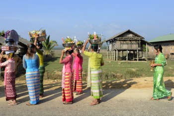 People in traditional dresses at a shinpyu ceremony in a village neat the city of Myeik in the south in Myanmar in Southeastasia. Credit: urf/Depositphotos
