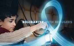 Child holding a lantern with Solidarity with Refugees written. World Refugee Day 2025 banner. Credit: UNHCR