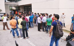 Migrant workers queuing outside building