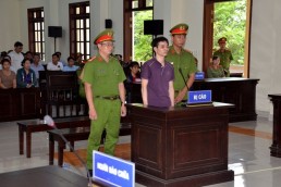 This photo taken and released by Vietnam News Agency on June 6, 2019 shows environmental activist Nguyen Ngoc Anh [center] standing in a courtroom during his trial in southern Vietnam's Ben Tre province. Credit: AFP