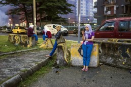 Four female foreign workers from Indonesia taking a break to check their phones off-work at a nearby hi-tech factory in Petaling Jaya, Malaysia. Credit: UN Women