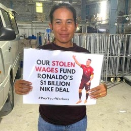 Ramatex worker holding sign saying Our stolen wages fund Ronaldo's $1 billion Nike deal. Credit: Pay Your Workers campaign