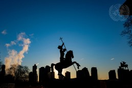 Sun rises behind statue Good Defeats Evil at UN Headquarters in New York. Credit: UN Photo/Manuel Elias